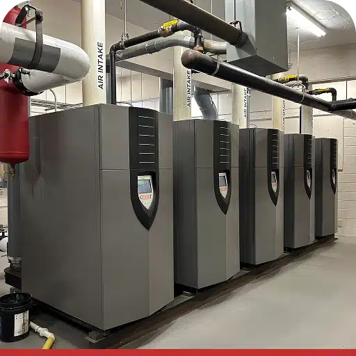 Series of commercial HVAC units aligned in a mechanical room