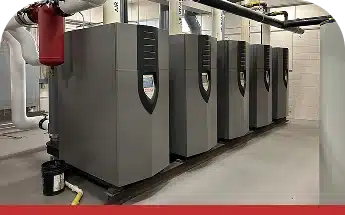 Series of commercial HVAC units aligned in a mechanical room