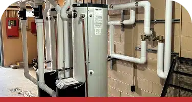 Commercial boilers lined up in a mechanical room