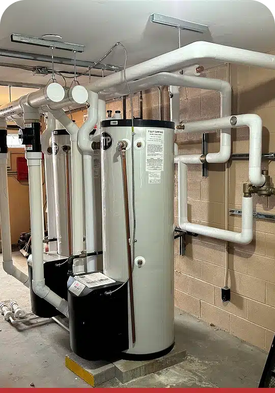 Commercial boilers lined up in a mechanical room